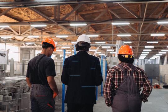 Engineering team walking through industrial factory production
