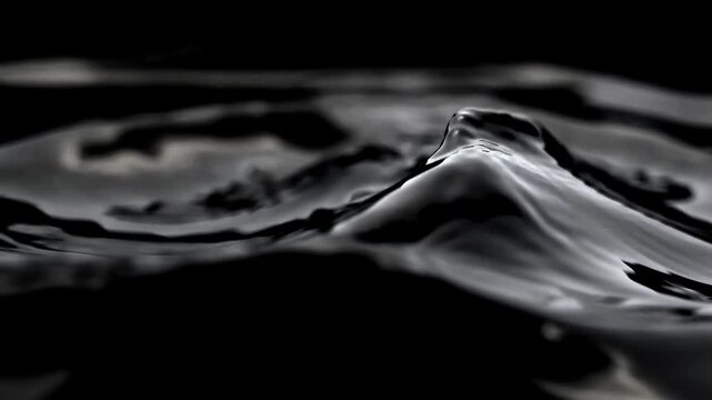  black ferrofluid liquid moving in slow motion on dark background. Abstract glossy magnetic fluid waves shifting in slow motion, premium nano technology or crude oil concept, 4K.
