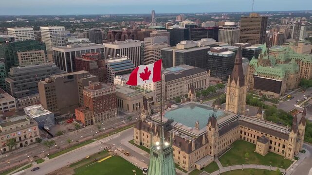 Canadian Flag Flying Above Parliament Hill Ottawa Canada at Sunset Aerial Drone View