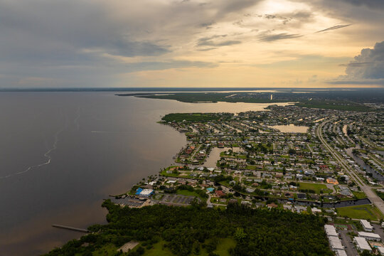 Intense thunderstorm above Charlotte Harbor, Florida. Rainwater falling from storm clouds onto coastal neighborhoods.