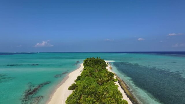 Aerial view of a tropical island with white sand beaches and lush palm trees surrounded by turquoise ocean water in Fulhadhoo, Baa Atoll, Maldives.