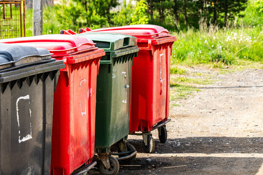 A Row of Colorful Recycling Bins on a Sunny Day, Highlighting Waste Management and Environmental Care in an Outdoor Setting