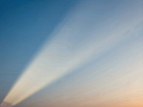 Soft gradient sky and light beam at dawn or dusk