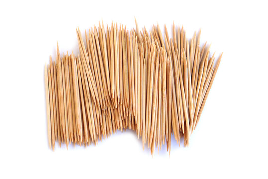 Wooden toothpicks bundle isolated on white background. Natural bamboo sticks with sharp tips arranged in pattern, representing hygiene, kitchen tools, food serving, and minimal design concept.