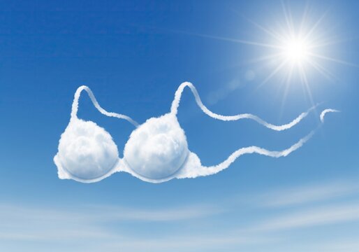 A bra shape formed from clouds against a bright blue sky with the sun shining