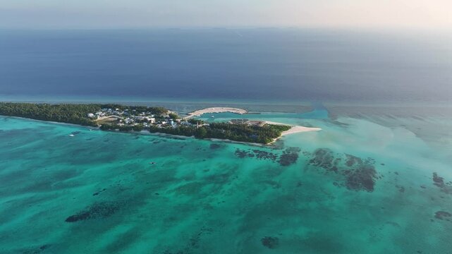Aerial view of the tropical island of Fulhadhoo with turquoise lagoons, coral reefs, and lush palm trees in the Baa Atoll, Fulhadhoo, Baa Atoll, Maldives.