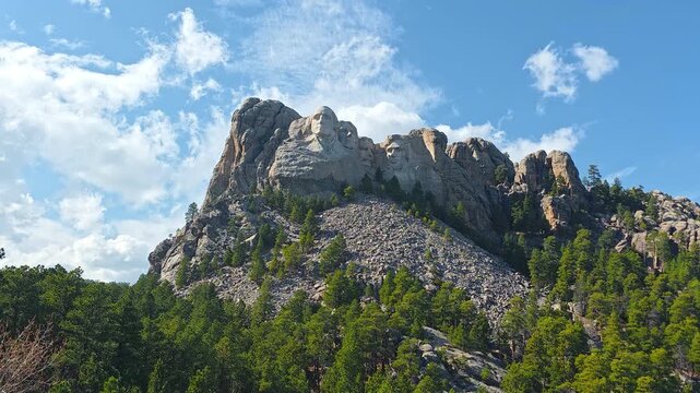 USA, April 2, 2026, Mount Rushmore National Memorial Close View, Editorial travel video frame showing granite presidential sculptures above pine forest and blue sky