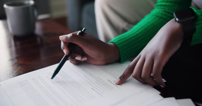 Focused Black Women Reviewing Business Documents with a Pen and Smartwatch