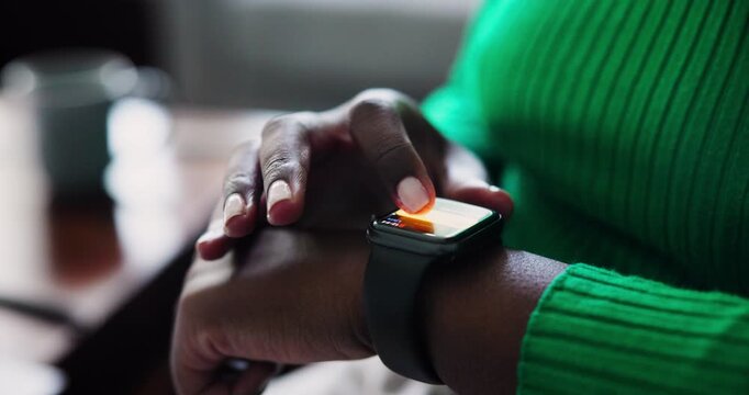Close-Up of a Black Women Hand Interacting with a Smartwatch Display, Showcasing Modern Technology and Connectivity