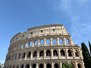 Fototapeta premium The historic Colosseum amphitheater on a bright sunny day in Rome, Italy