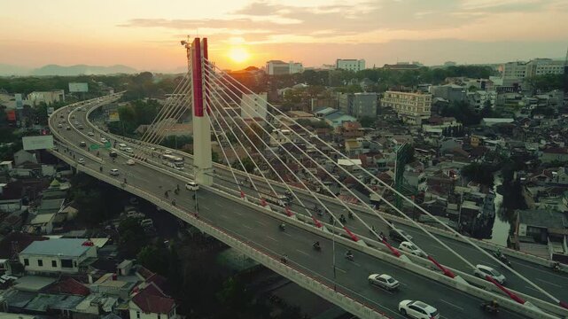 Aerial view of the city's iconic Pasupati Bridge, with the afternoon sun in the background of Bandung, West Java, Indonesia