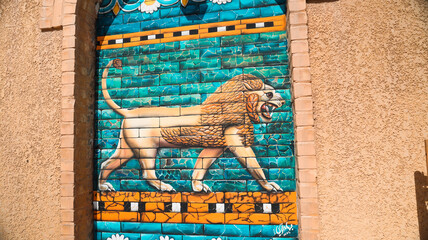 Vibrant lion mural adorns ancient walls in Babylon Iraq reflecting cultural heritage © Dave
