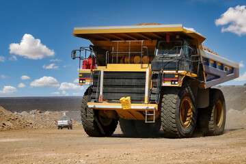 : Mining dump truck transporting earth material at an open pit mine site © poco_bw