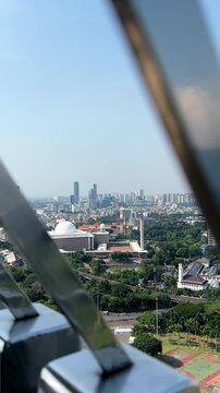 Jakarta, Indonesia, June 4, 2026: A view of Jakarta from the top of the National Monument (Monas), including a view of Istiqlal Mosque.