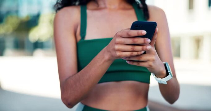 Cellphone, fitness and hands of woman in city with typing for texting, social media or chatting. Athlete, technology and female person scrolling on app for workout program on phone in urban town.