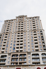Fototapeta premium Charming facade with stylish features. Architectural elements highlight urban residential aesthetics. Sculpted archways and canopy details enhance city street appearance