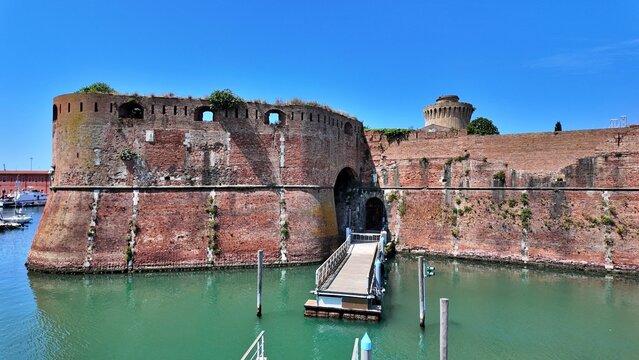 Livorno, Tuscany, Italy - 06.27.2026: view of Historic Old fortress with a moat and docked sailboats, showcasing Livorno's maritime heritage and architecture