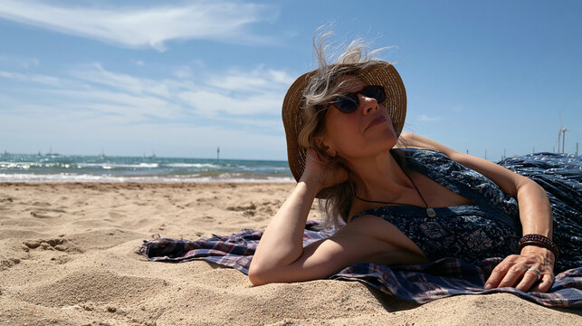 Senior Woman Relaxing on Sandy Beach 