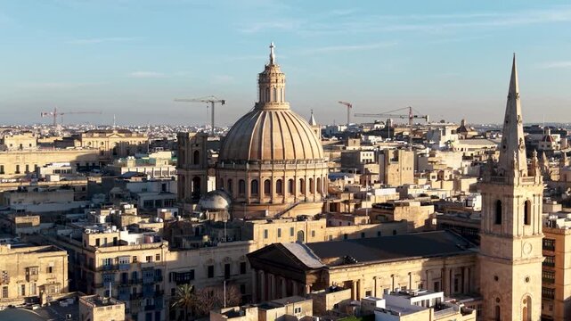 Aerial view of the Basilica of Our Lady of Mount Carmel and St Paul's Pro-Cathedral among historic limestone buildings in Valletta, Port Region, Malta.