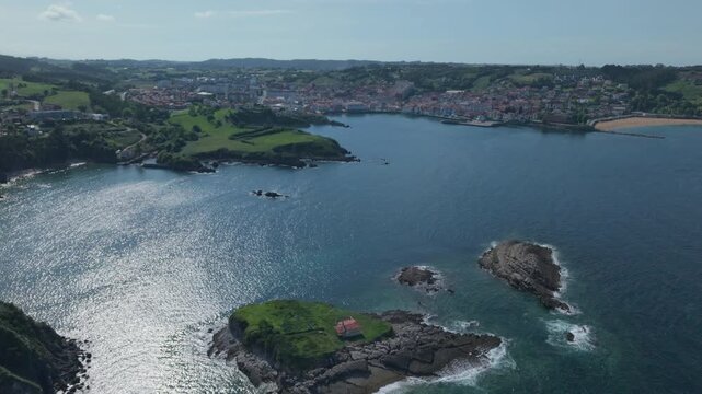 Scenic aerial view of the coastal town of Luanco, Spain with Islet of Carmen and the Cantabrian sea in the foreground