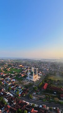 Drone View of Grand Mosque with Green Dome and Four Minarets at Sunset in Indonesia