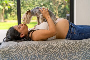 Naklejka premium Pregnant woman bonding with pet dog