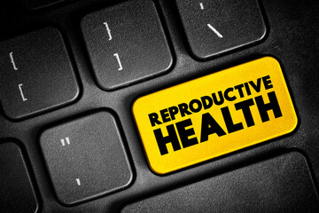 Obraz premium Reproductive Health - condition of male and female reproductive systems during all life stages, text button on keyboard, concept background