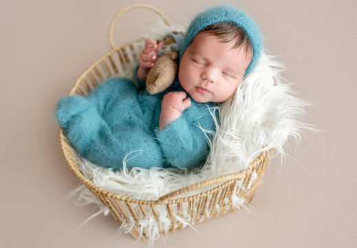 Newborn Baby Sleeping In Basket During Newborn Photographer Photoshoot