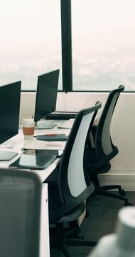 Empty, coworking office and corporate workspace for insurance company, finance firm and desks. Computer, chairs and window setup at agency for wealth management, workstation and debt consolidation