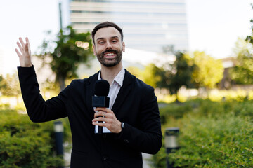 Professional male journalist holding microphone presenting breaking news