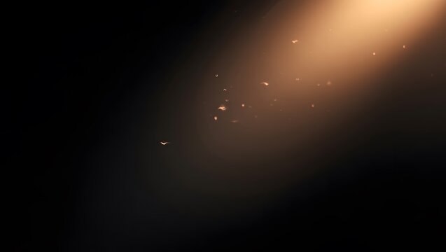 Cinematic golden light beam with floating dust particles in darkness