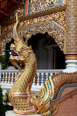 Fototapeta premium Colorful naga serpent sculpture at Thai Buddhist temple entrance
