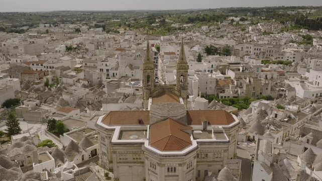 Aerial views of Alberobello&rsquo;s iconic trulli rooftops, winding streets, and sunlit limestone houses, capturing the charm and symmetry of this UNESCO-listed Italian village.