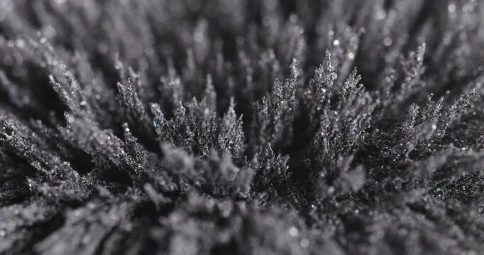 Metal dust, shavings, iron powder under the influence of a magnetic field. Abstract background.