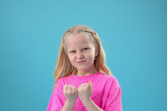 Happy childhood and festive moments with happy little girl showing punch gest