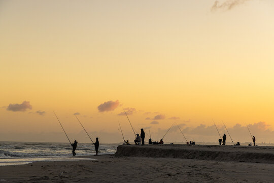 fishermen , Atlantic Ocean , grotto lagoon and Atlantic Ocean at dusk, Hermanus, South Africa