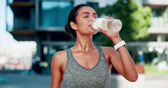 City, woman and fitness break for drinking water, hydration and liquid beverage for workout. Training, female person or rest with bottle for mineral H2O, thirst or wellness for exercise in summer