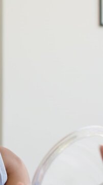 Vertical video: Mirror entering frame woman in tank moving mirror at home showing pink nails watch