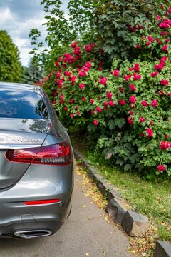 Uzhgorod, Ukraine. April 2026. Vertical detail of car rear red taillight and luxury sedan bumper