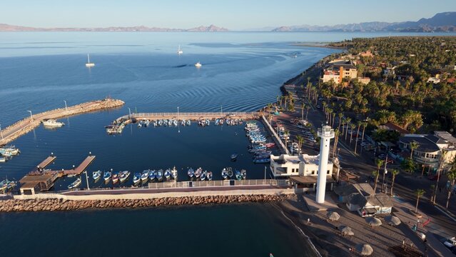 Explore the sunset over Loreto marina in Baja California Sur, Mexico, where the desert meets the water in a unique landscape