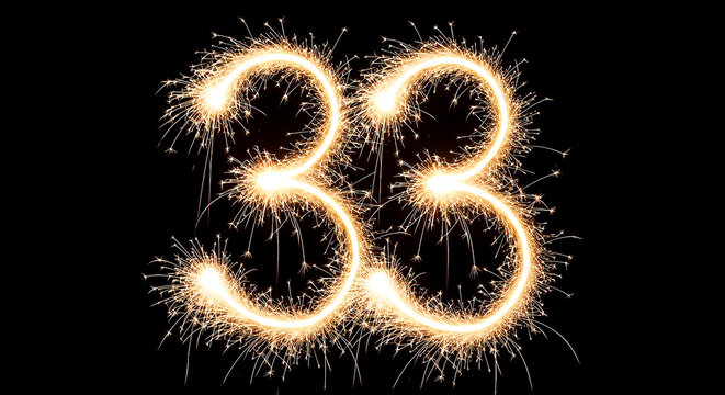 Vibrant sparklers arranged to create the number 33, glowing brightly against a dark backdrop for a festive or celebratory effect.