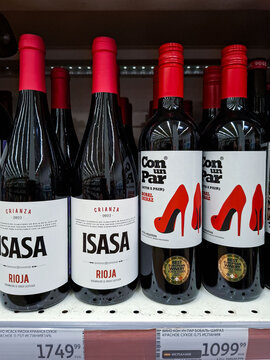 Voronezh, Russia - April 11, 2026.Close up of Isasa Rioja and Con un Par Bobal Shiraz red wine bottles on supermarket shelf in Russia