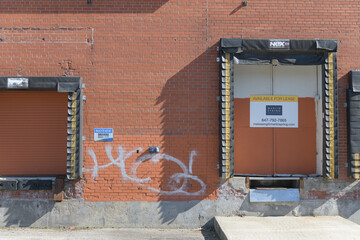 Obraz premium old dock portals with Real Estate sign at 2255 St Clair Av W, Toronto (formerly CMP Meats)