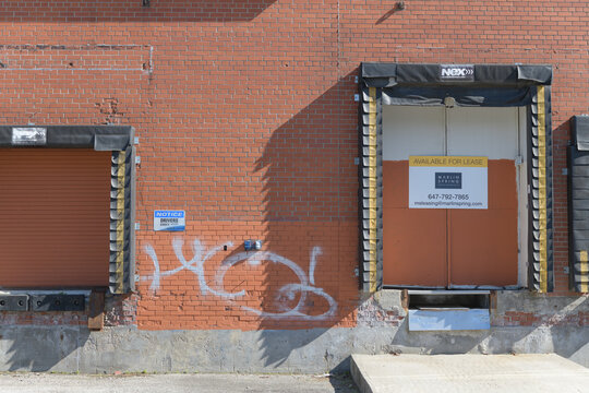 old dock portals with Real Estate sign at 2255 St Clair Av W, Toronto (formerly CMP Meats)