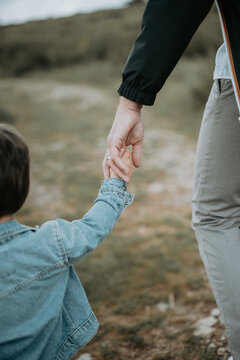 Jeune enfant marchant en tenant la main de son p&egrave;re