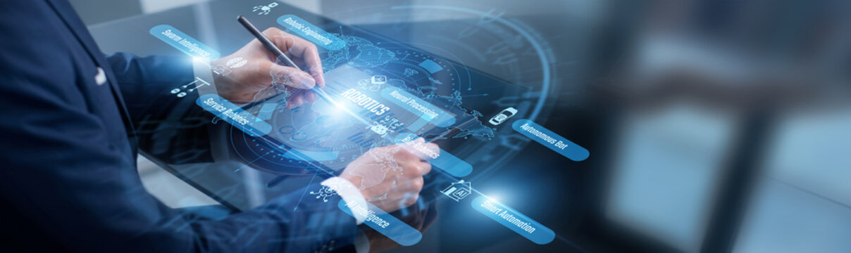 Mechanical engineer point of advanced robotics. Engineer using tablet programming auto-bots across the vast industrial network. Automating physical labor and increasing precision tasks.