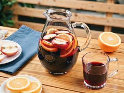 Refreshing sangria pitcher with fruit slices outdoors
