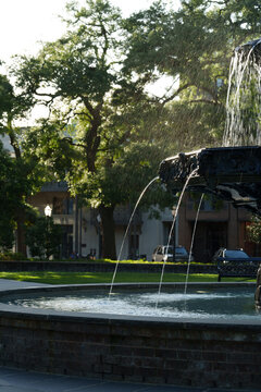 Ornate Bronze Fountain with Water Jets in Urban Park
