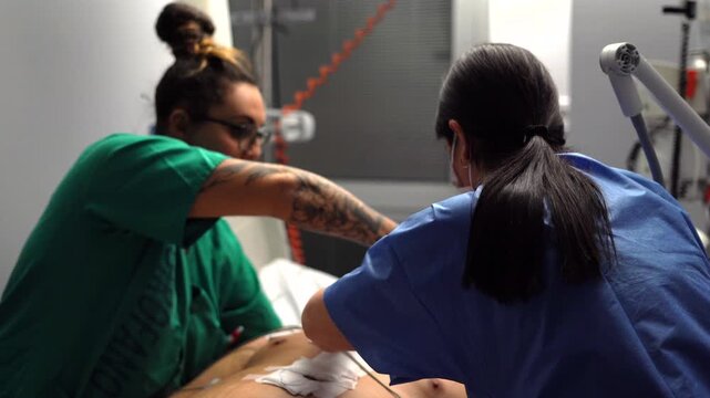Medical staff performing first aid on patient
