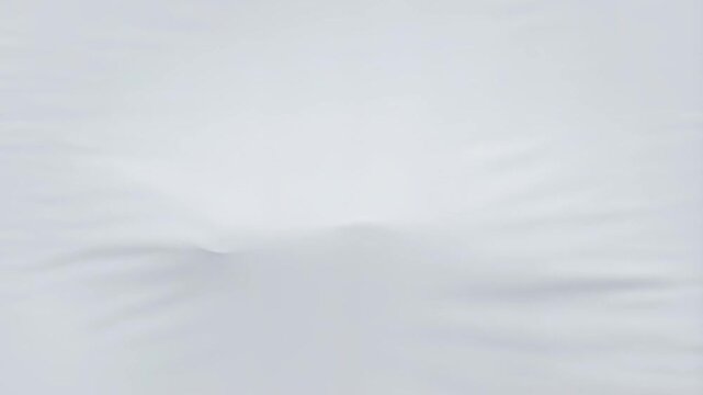 Flowing white fabric forms dynamic waves in motion